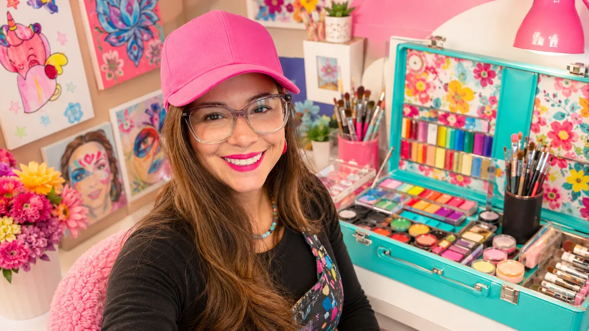 Jely at a colorful museum-style event setup for Utahmania content creation.